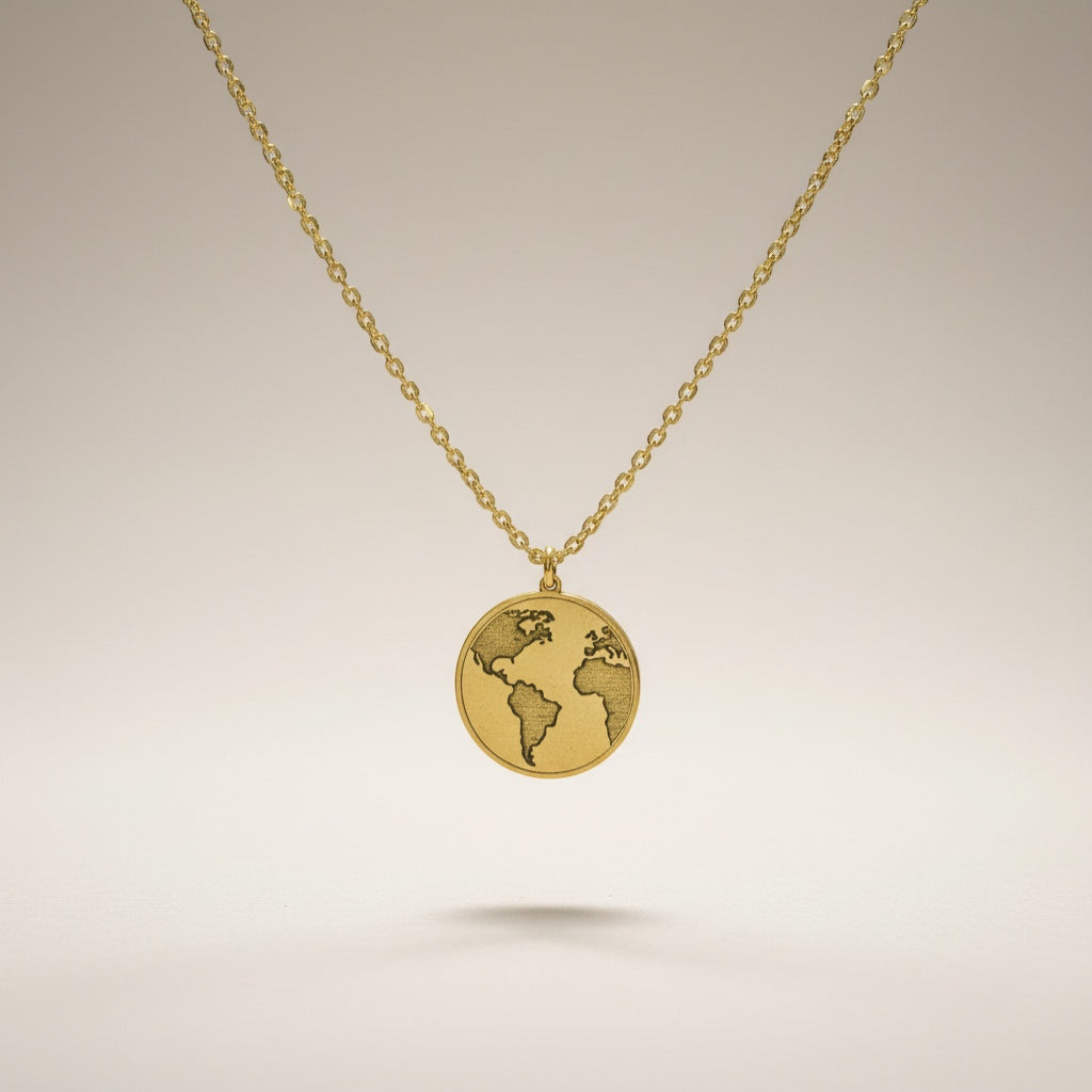 Bedrock Rose gold world pendant necklace with intricate laser engraving on a faceted stainless steel chain.