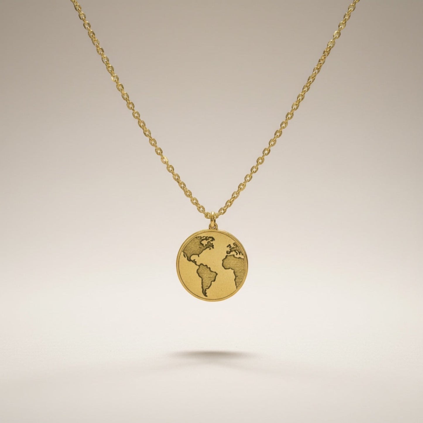 Bedrock Rose gold world pendant necklace with intricate laser engraving on a faceted stainless steel chain.