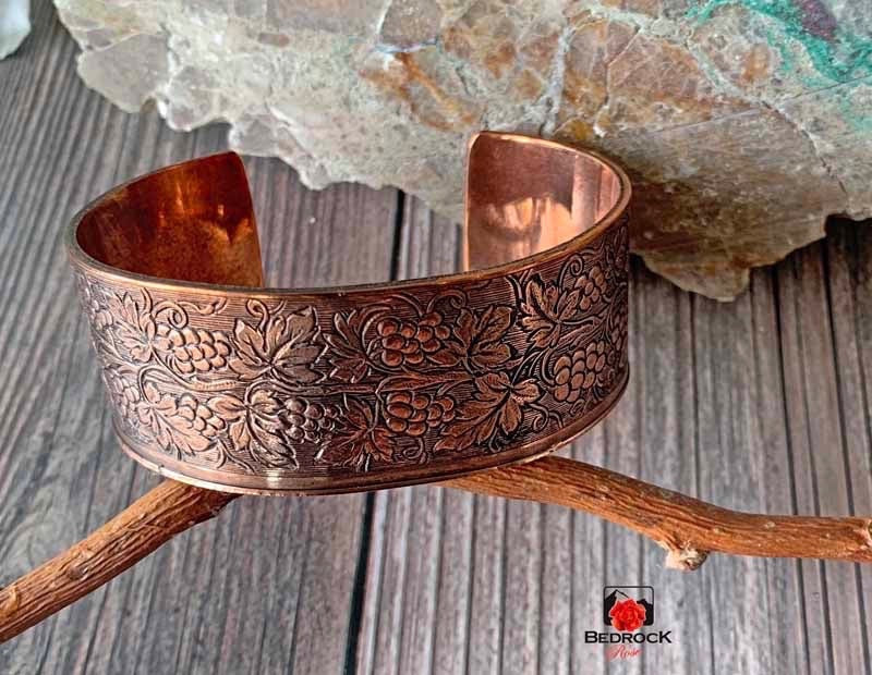 Bedrock Rose medium copper cuff bracelet featuring an ornate, polished grapevine pattern with detailed patina.