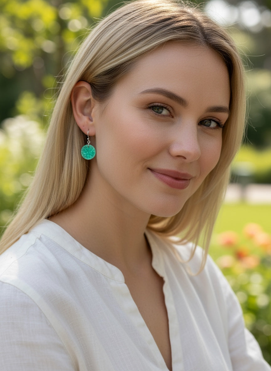 Bedrock Rose circular dangle earrings featuring transparent green enamel over roll-printed fine silver grape motifs.
