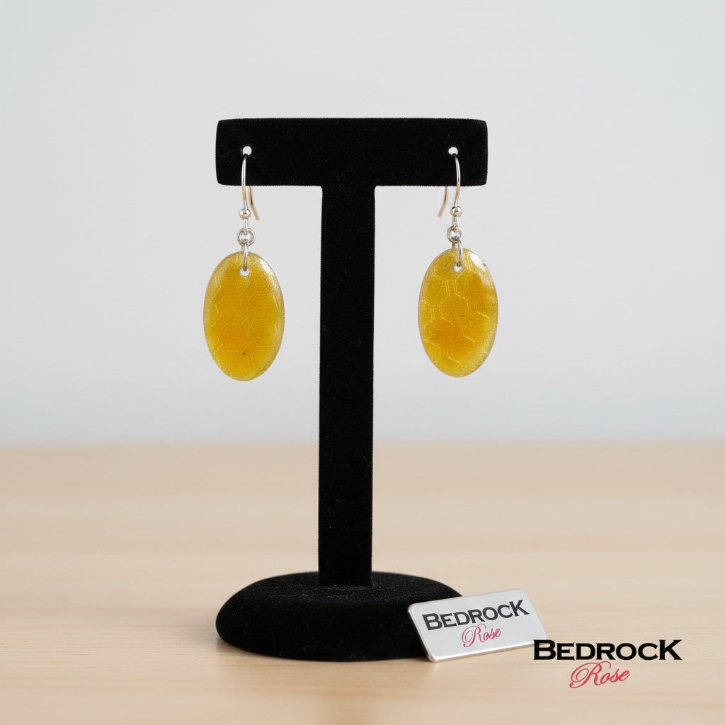 Bedrock Rose oval dangling earrings featuring a honey-colored honeycomb pattern in vitreous enamel on fine silver.