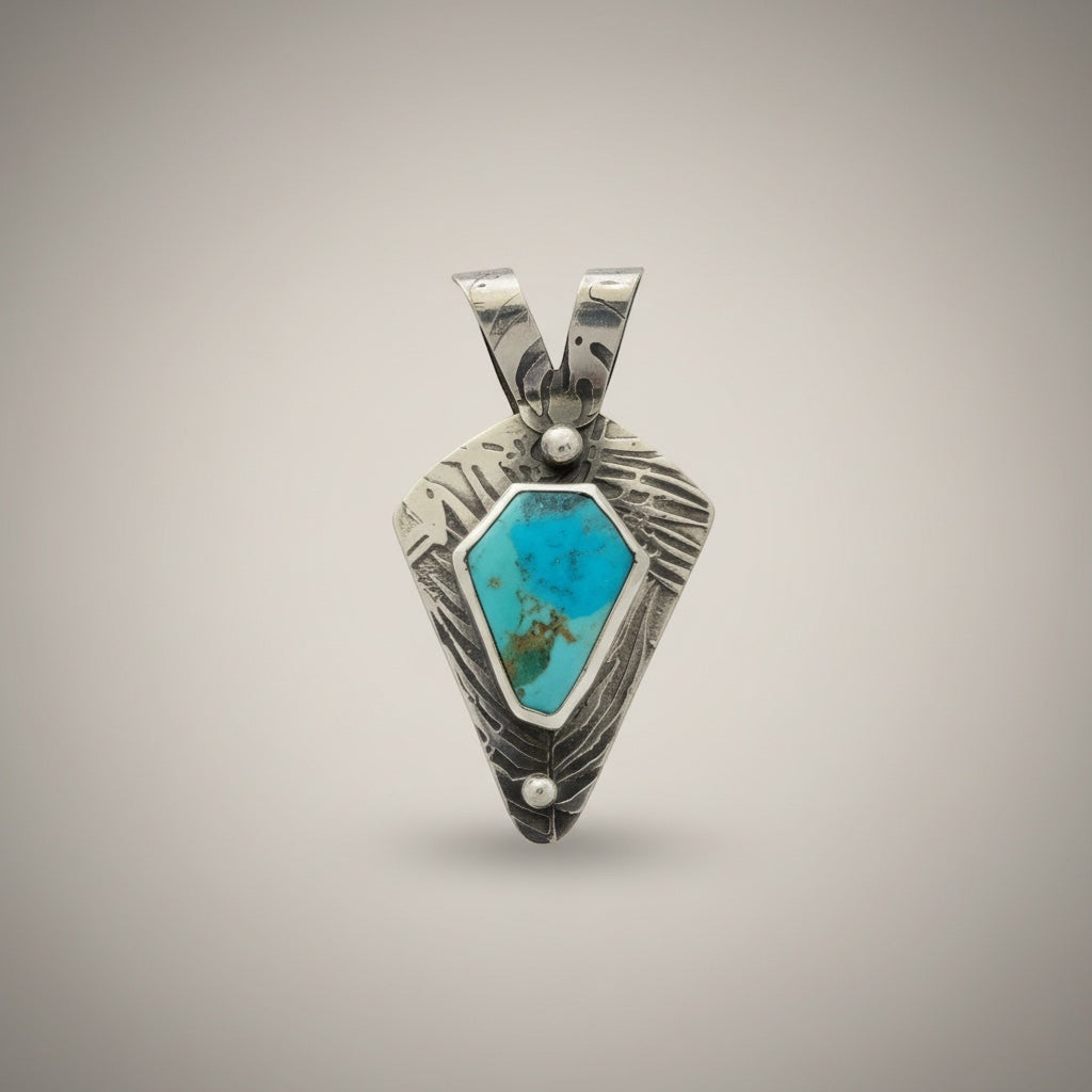 Bedrock Rose Kingman Turquoise sterling silver pendant with textured detailing and an 18-inch faceted chain.