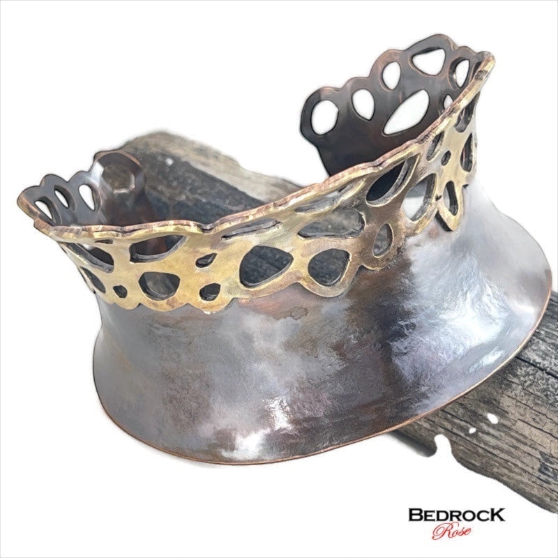 Bedrock Rose lacy pierced cuff bracelet featuring a wide dark copper base with a decorative brass filigree edge.