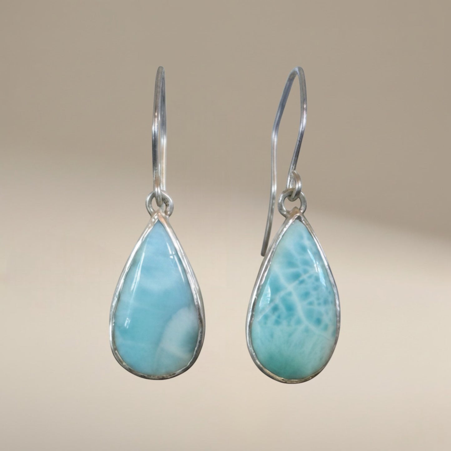 Bedrock Rose handcrafted sterling silver dangle earrings featuring natural blue Larimar teardrop cabochons.