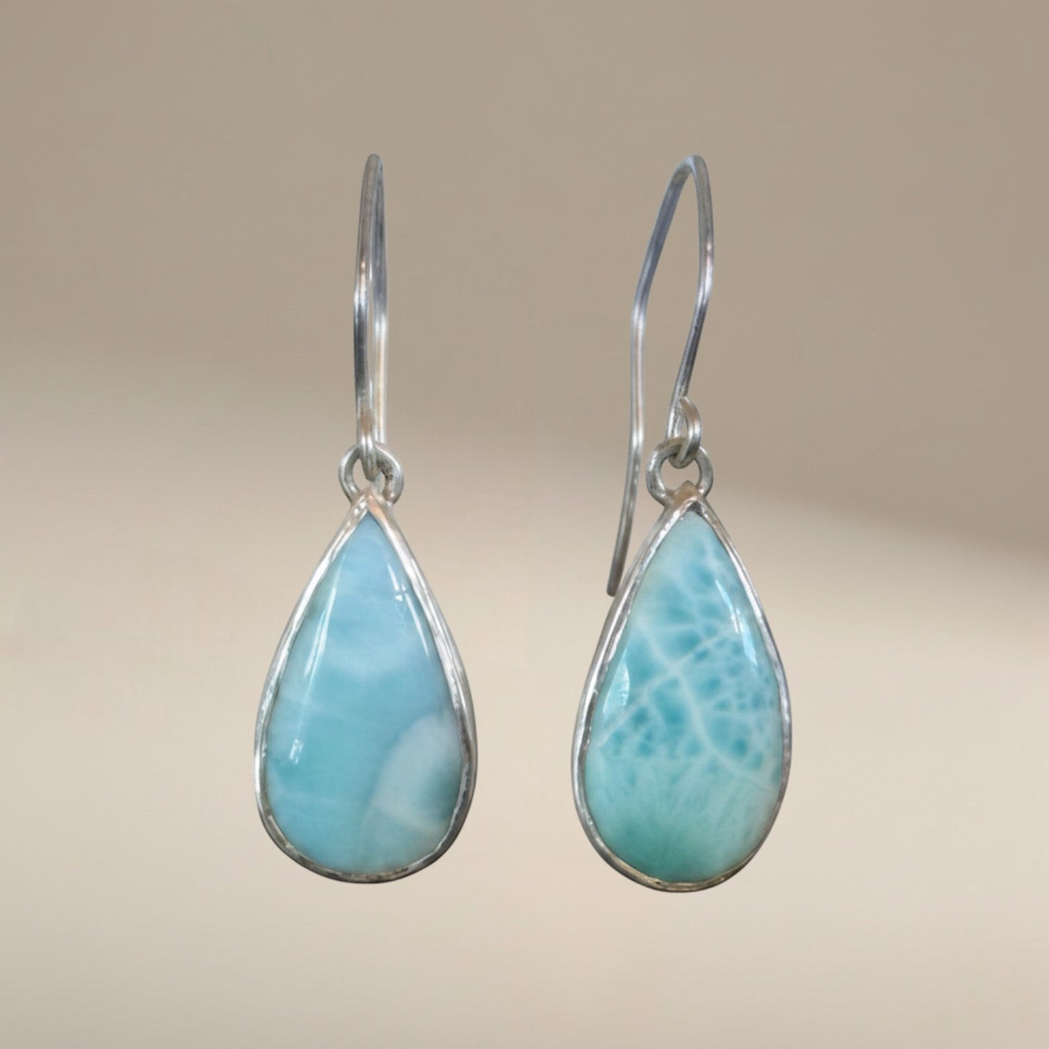 Bedrock Rose handcrafted sterling silver dangle earrings featuring natural blue Larimar teardrop cabochons.