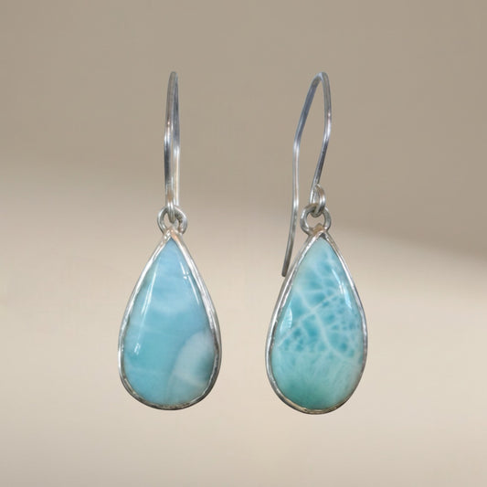 Bedrock Rose handcrafted sterling silver dangle earrings featuring natural blue Larimar teardrop cabochons.