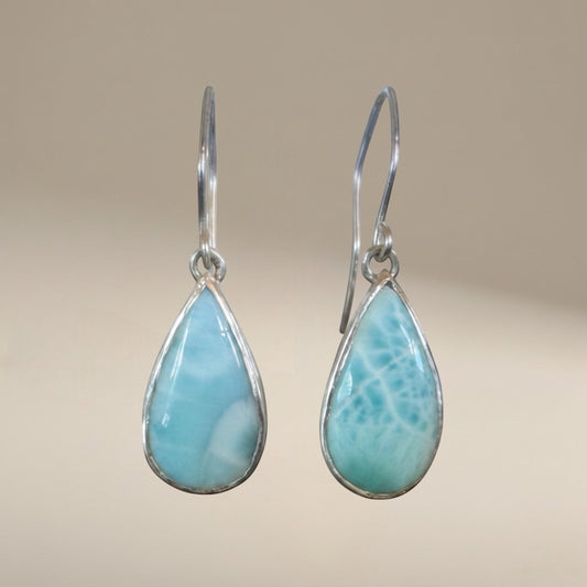 Bedrock Rose handcrafted sterling silver dangle earrings featuring natural blue Larimar teardrop cabochons.