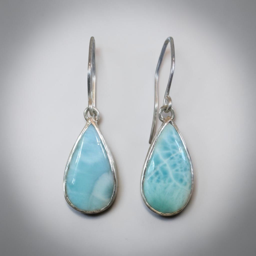 Bedrock Rose handcrafted sterling silver dangle earrings featuring natural blue Larimar teardrop cabochons.