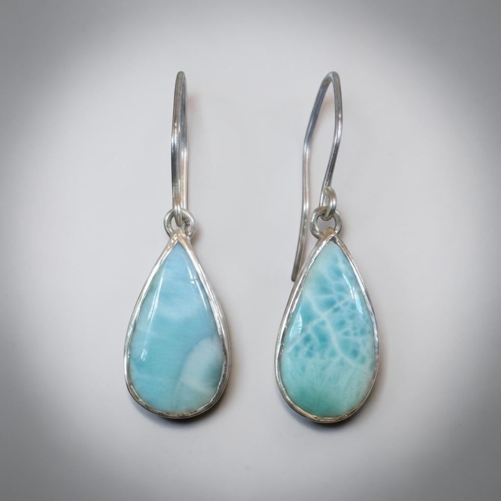 Bedrock Rose handcrafted sterling silver dangle earrings featuring natural blue Larimar teardrop cabochons.