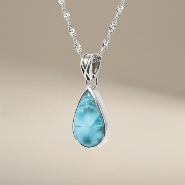 Bedrock Rose handcrafted sterling silver teardrop pendant featuring a blue and white swirling larimar gemstone.