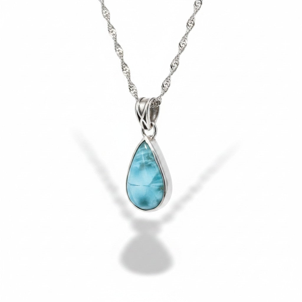 Bedrock Rose handcrafted sterling silver teardrop pendant featuring a blue larimar stone on a Singapore chain.