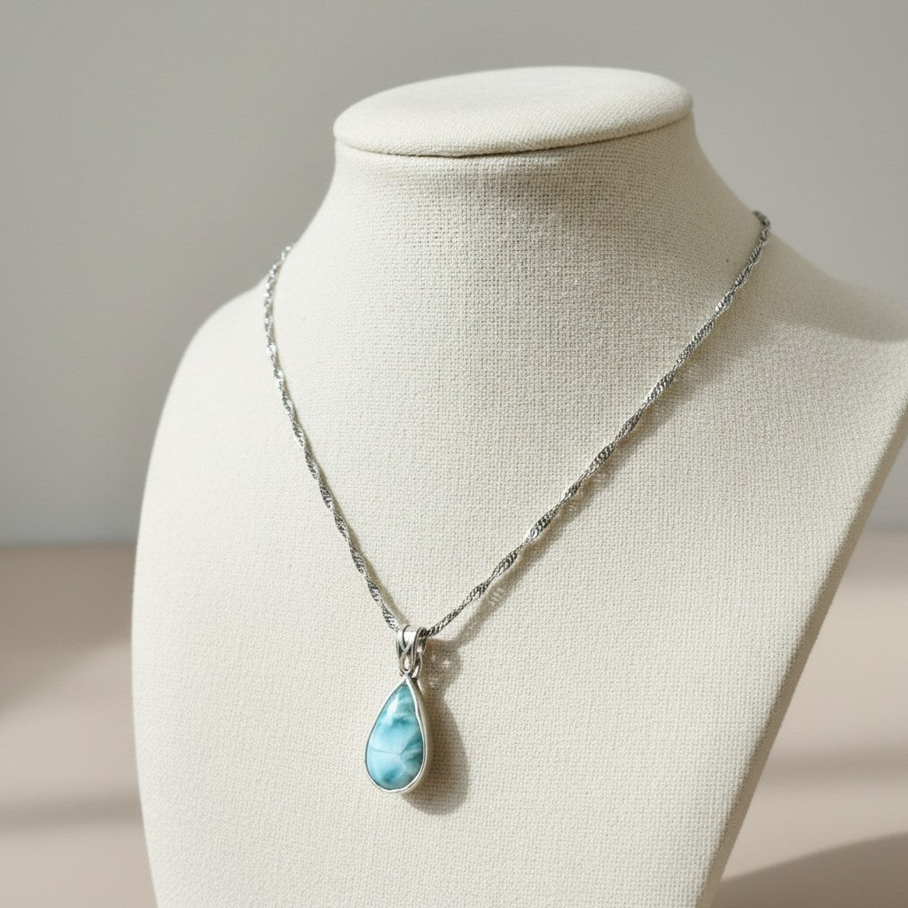 Bedrock Rose handcrafted teardrop larimar pendant in a sterling silver bezel on a stainless steel Singapore chain.