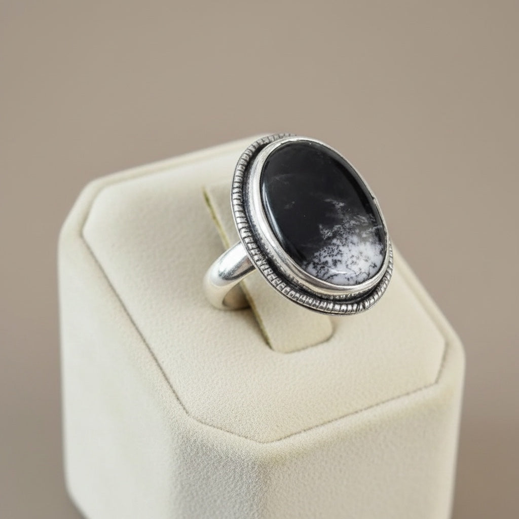 Bedrock Rose handcrafted sterling silver statement ring featuring an oval black and white Merlinite cabochon stone.