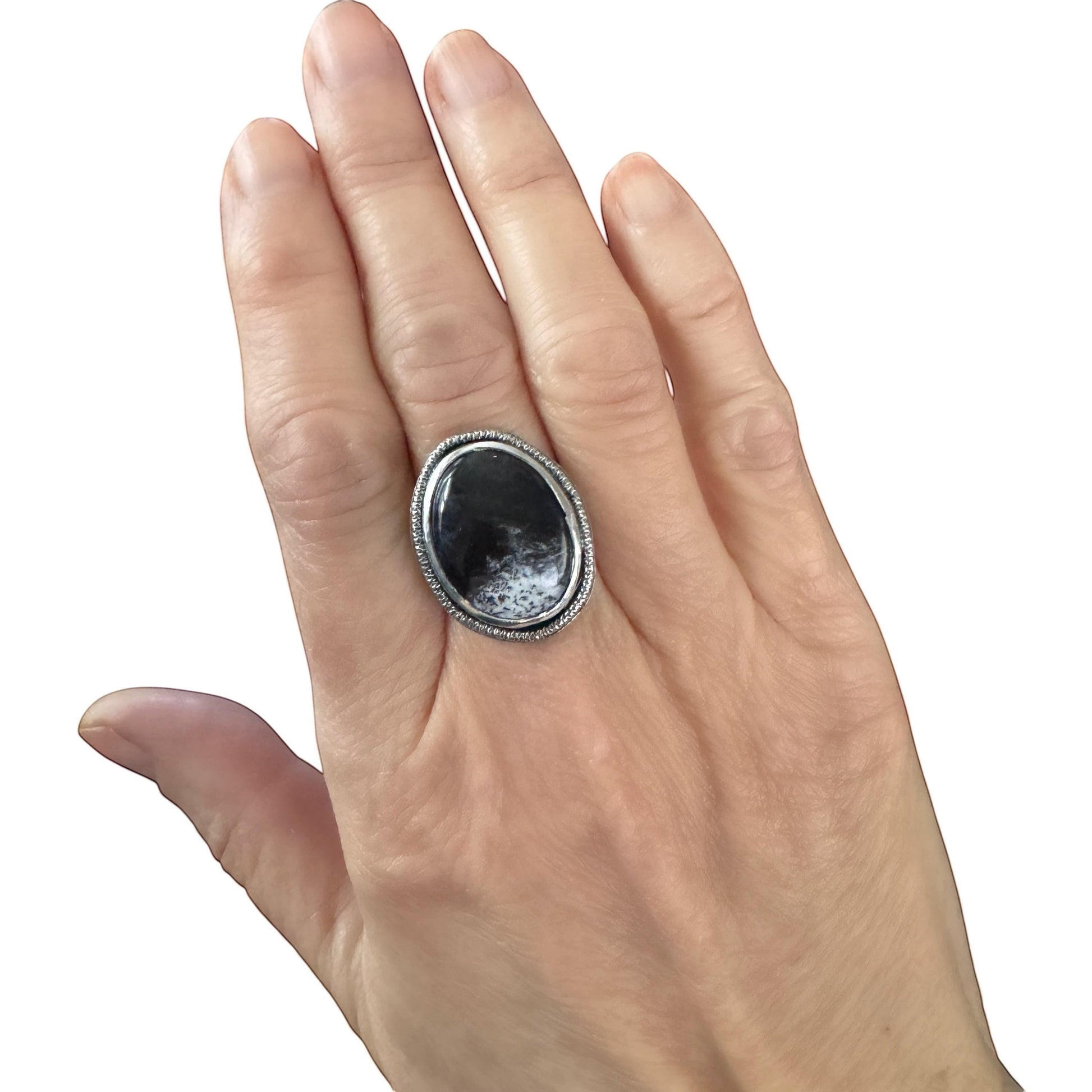 Bedrock Rose handcrafted sterling silver statement ring featuring an oval Merlinite cabochon with black and white patterns.