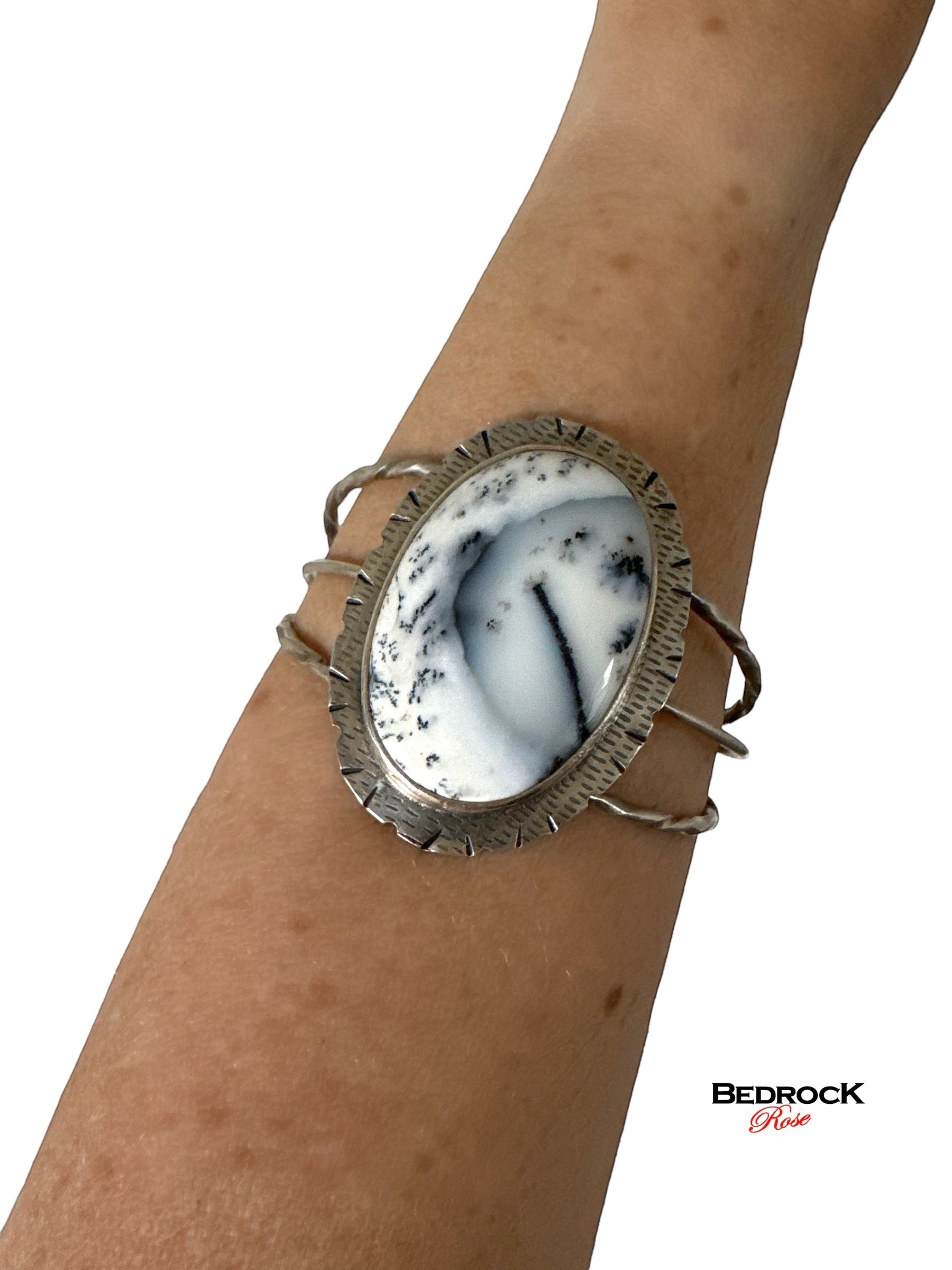 Bedrock Rose statement cuff bracelet featuring a large oval Merlinite stone set in textured sterling silver on a wrist