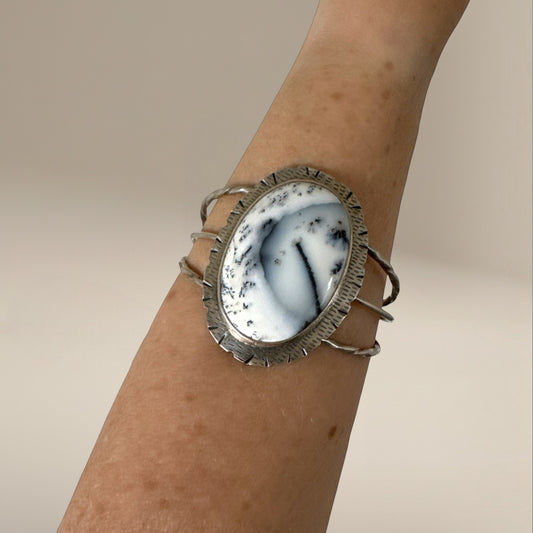 Bedrock Rose statement cuff featuring a large oval Merlinite stone set in textured sterling silver on a wrist
