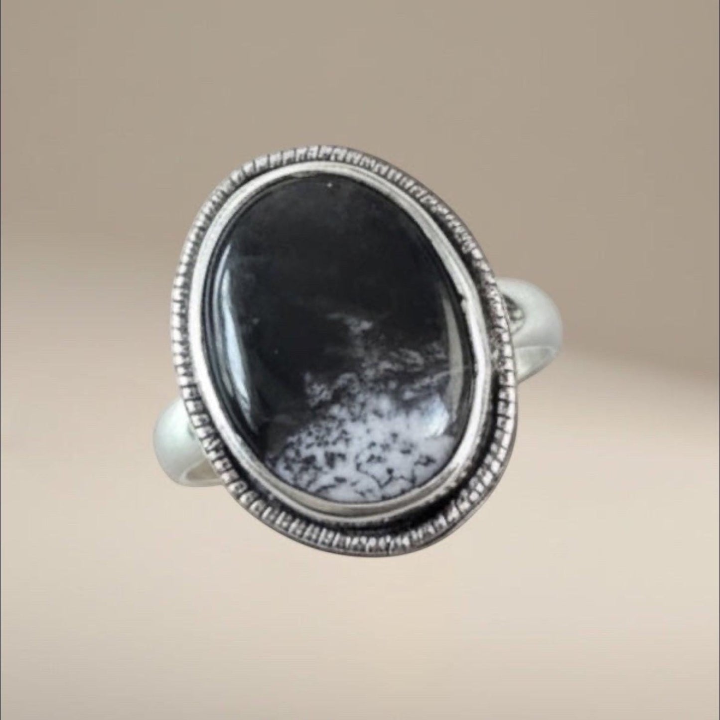 Bedrock Rose oval Merlinite statement ring in a textured sterling silver bezel setting with black and white patterns.
