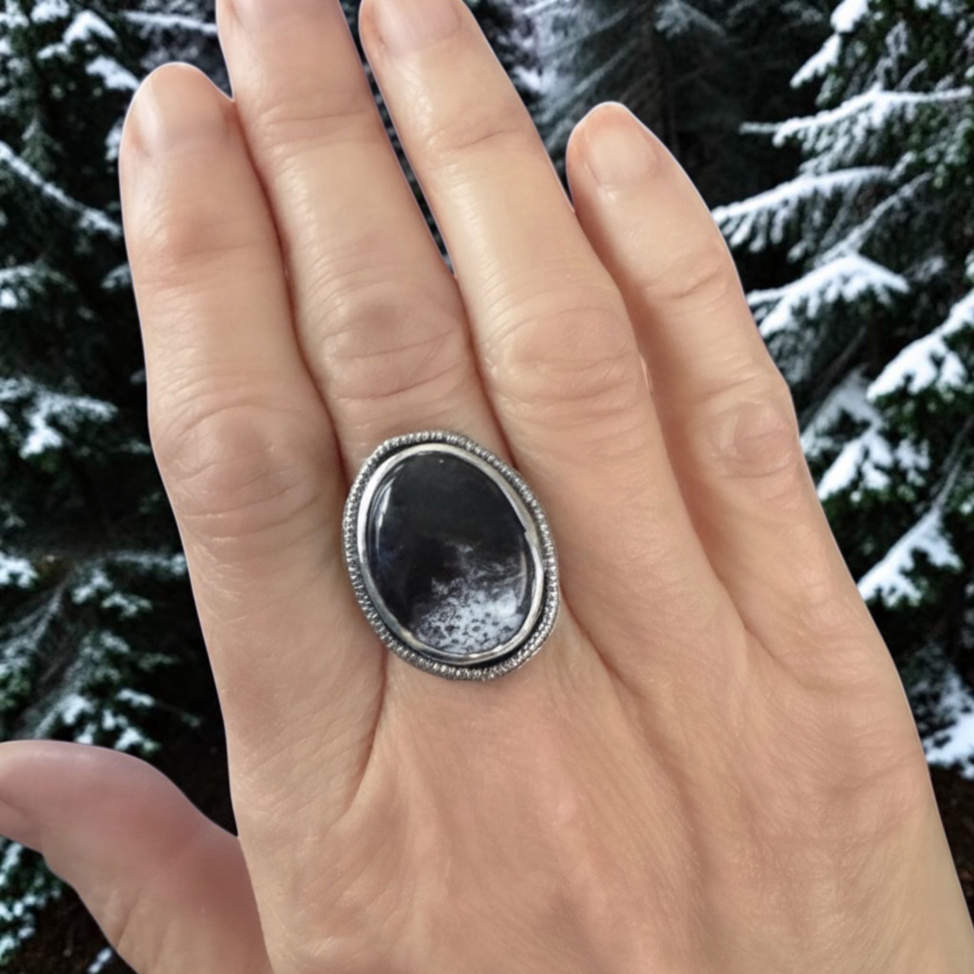 Bedrock Rose handcrafted sterling silver statement ring featuring an oval Merlinite cabochon with black and white patterns