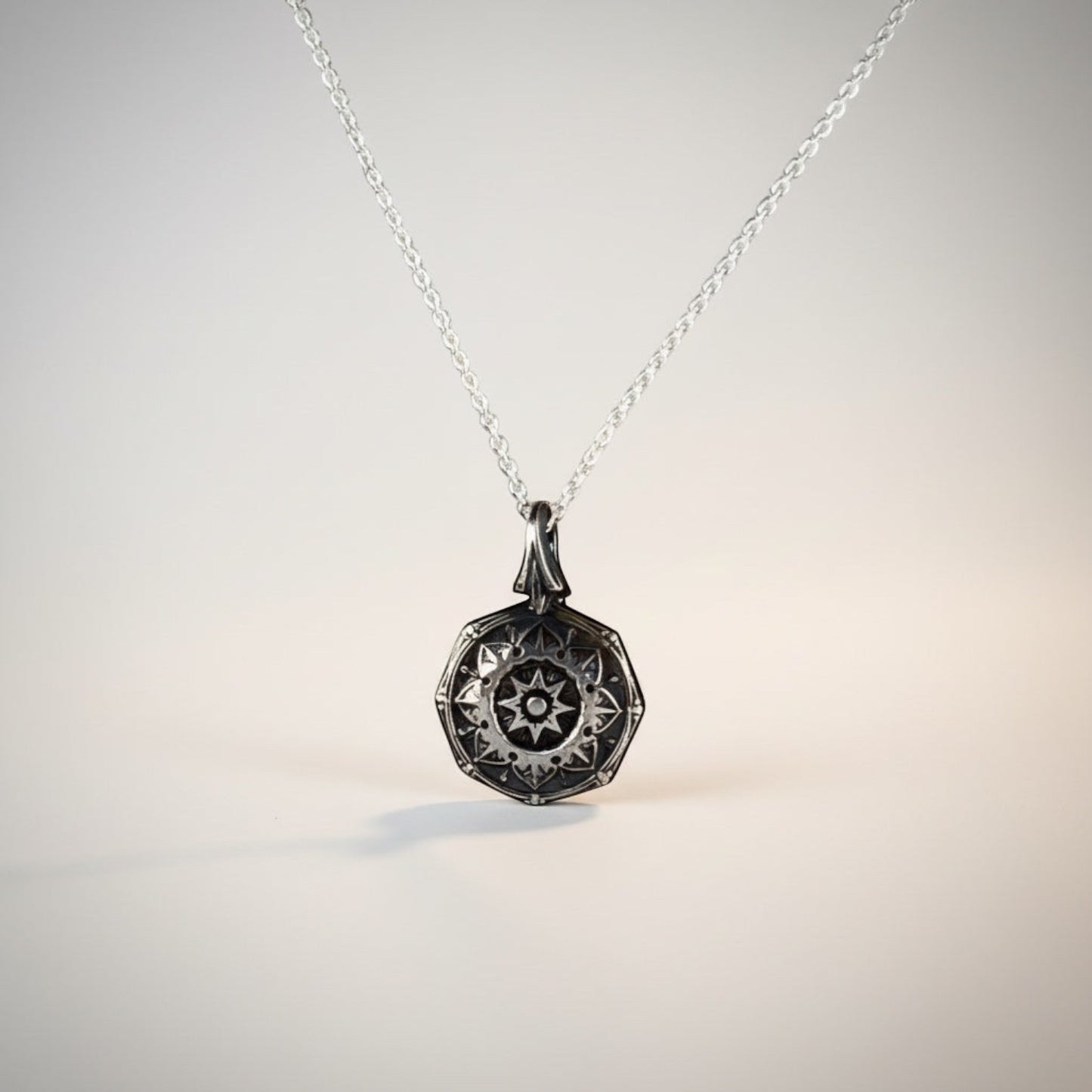 Bedrock Rose petite silver mandala pendant necklace with intricate spiritual design.