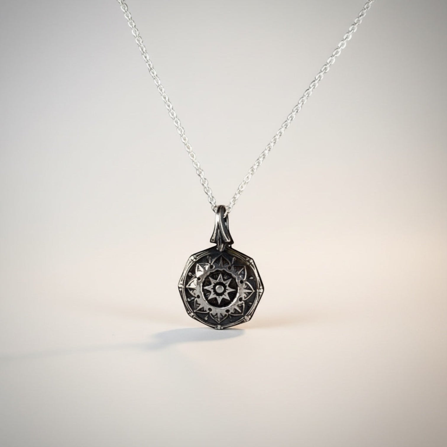 Bedrock Rose petite silver mandala pendant necklace with intricate spiritual design.