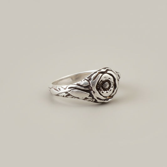 Bedrock Rose sterling silver ring with poppy flower design, size 7.5. Features detailed petals and leaves.