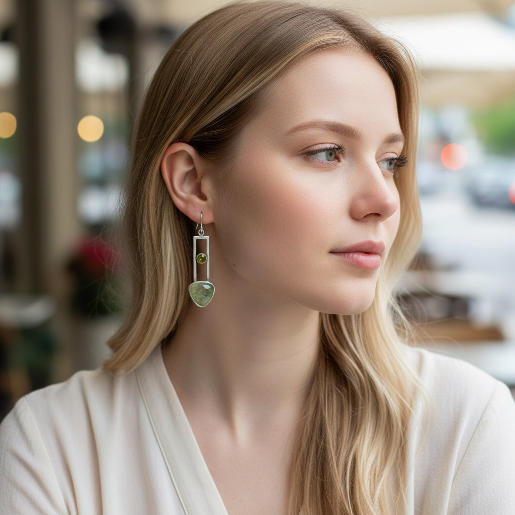 Bedrock Rose sterling silver dangle earrings with geometric design, featuring translucent pale green prehnite and olive-green peridot gemstones.