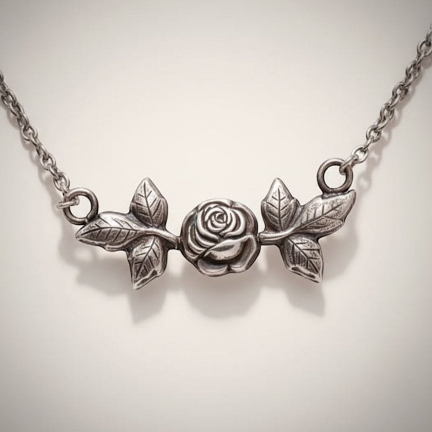 Bedrock Rose sterling silver necklace with rosebud and leaf design. Delicate pendant.