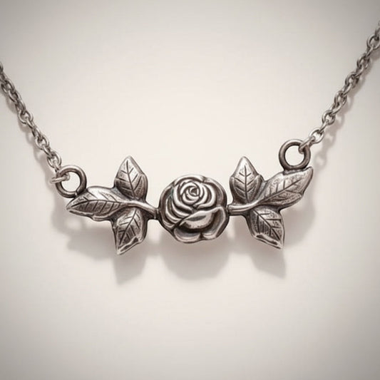 Bedrock Rose sterling silver necklace with rosebud and leaf design. Delicate pendant.