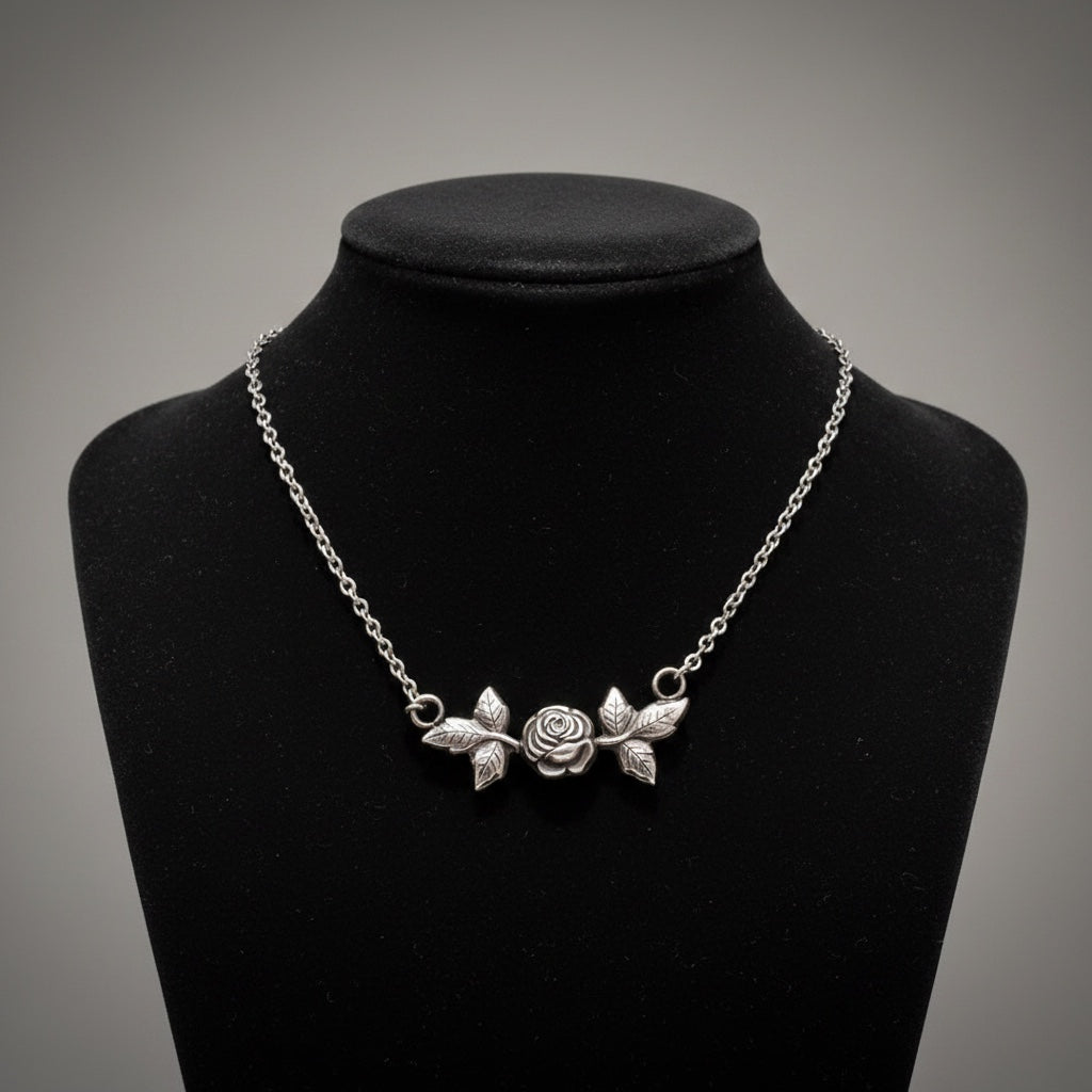 Bedrock Rose sterling silver necklace with rosebud and leaf pendant. Delicate floral design.