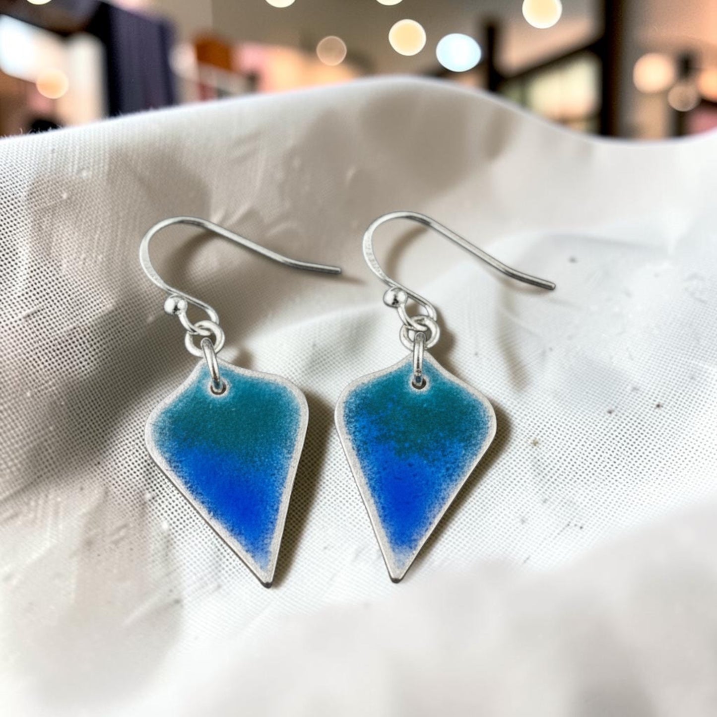 Bedrock Rose Seahawks shield dangle earrings in fine silver with a navy and action green gradient enamel finish.