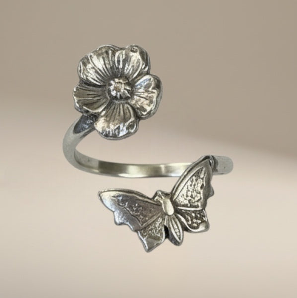 Bedrock Rose sterling silver wraparound ring with butterfly and flower design. Adjustable summer jewelry.