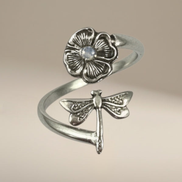 Bedrock Rose sterling silver wraparound ring with a dragonfly landing on a flower. Adjustable summer jewelry.
