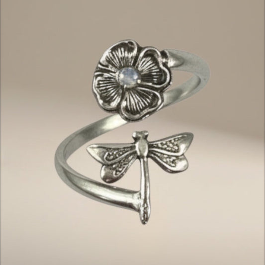 Bedrock Rose sterling silver wraparound ring with a dragonfly landing on a flower. Adjustable summer jewelry.