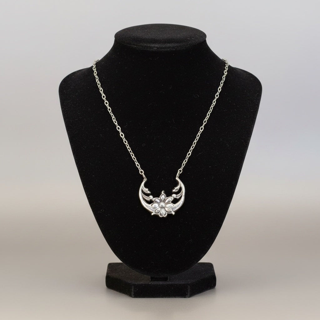 Bedrock Rose sterling silver floral crescent pendant necklace with a delicate flower motif. Inspired by the moonflower and solar eclipse.