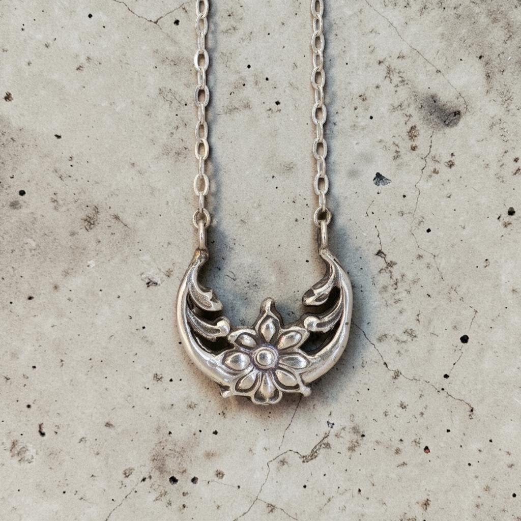 Bedrock Rose Sterling Silver floral crescent pendant necklace with a flower motif and 16" chain.