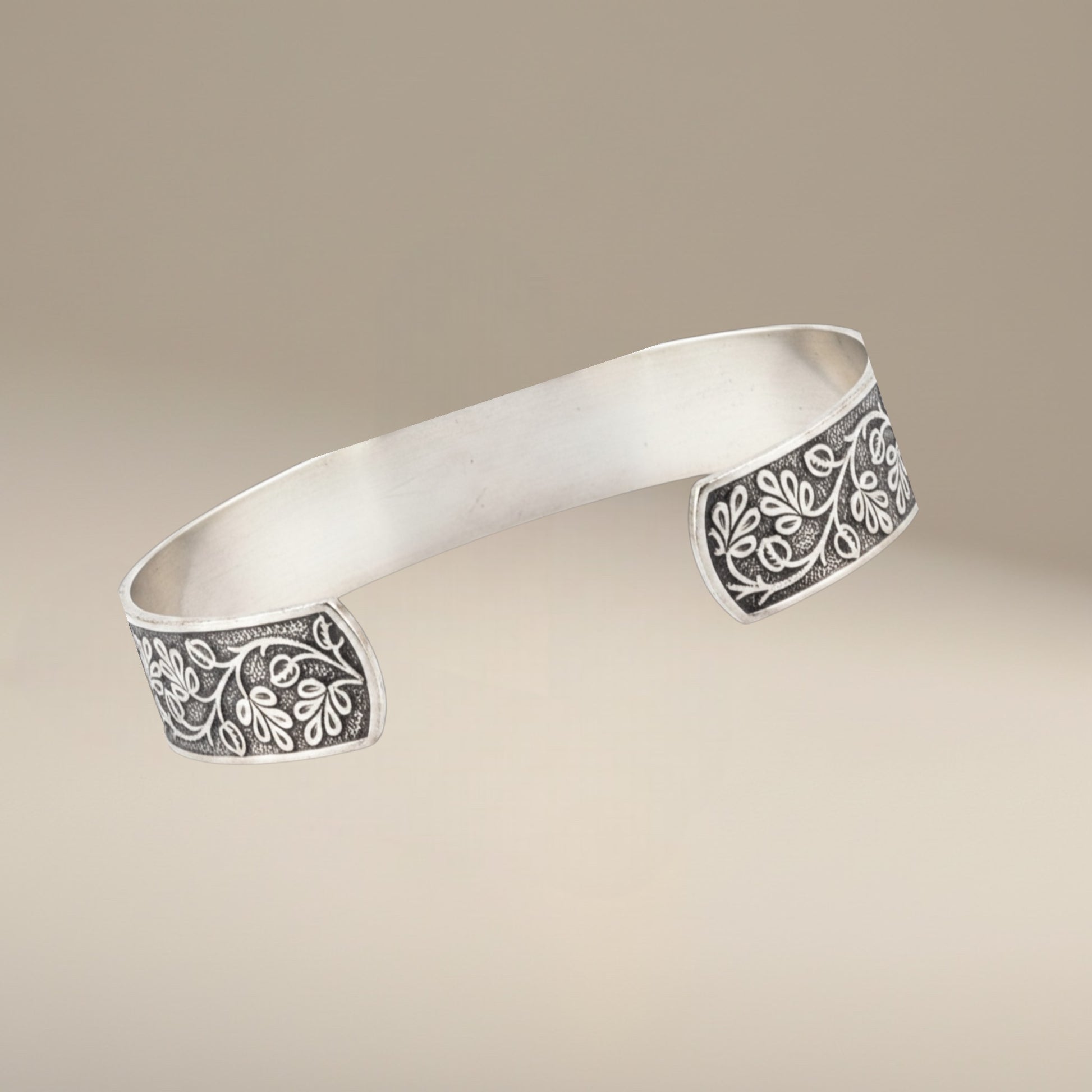 Bedrock Rose sterling silver-plated cuff bracelet featuring an intricate vintage floral vine pattern.