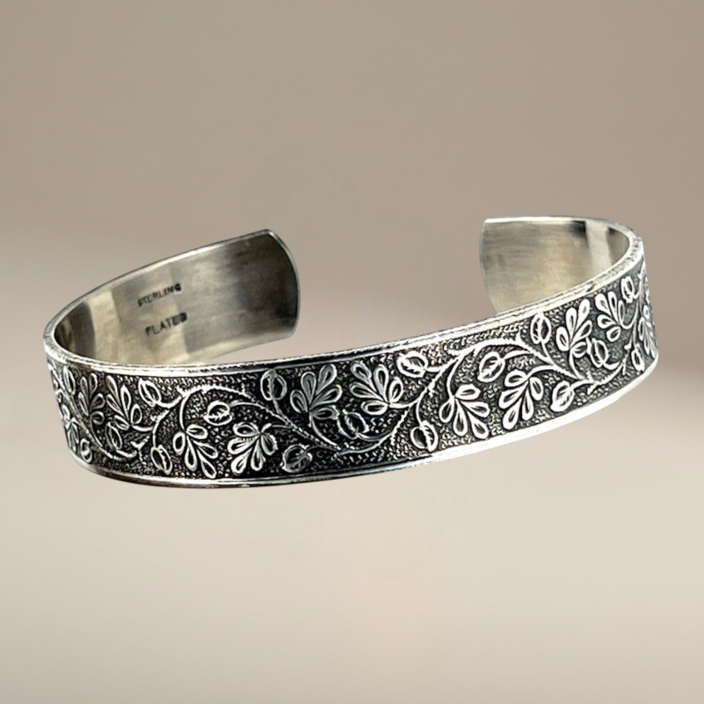 Bedrock Rose sterling silver-plated cuff bracelet featuring an intricate vintage floral vine pattern with patination.