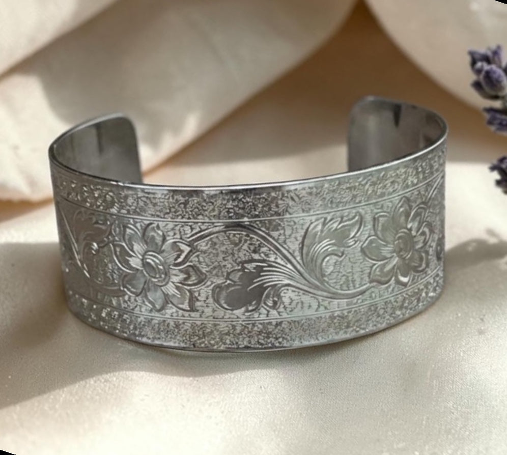 Bedrock Rose sterling silver-plated cuff bracelet featuring an intricate engraved floral flourish pattern.