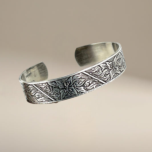 Bedrock Rose sterling silver-plated cuff bracelet featuring an intricate floral monument design with deep patination.