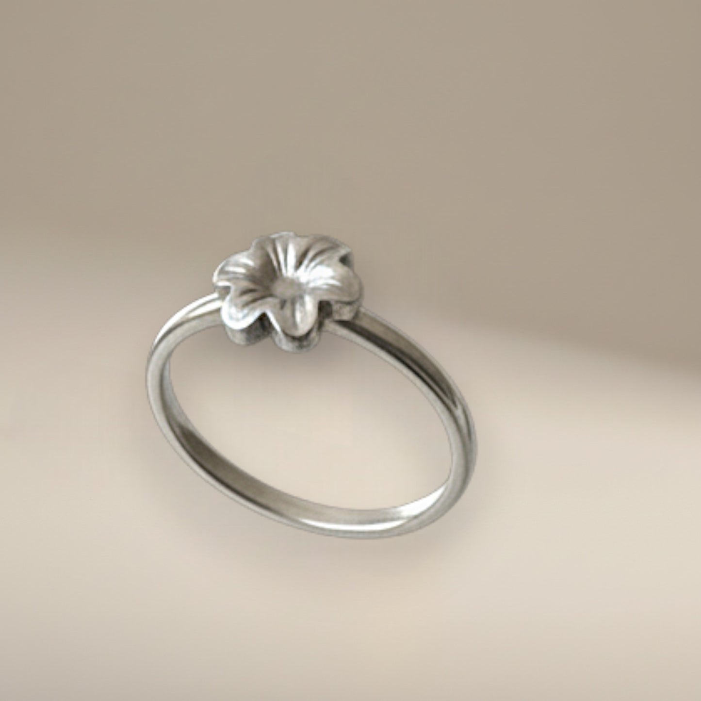 Bedrock Rose sterling silver ring featuring a dainty six-petal meadow flower design on a slim band, size 5.25.