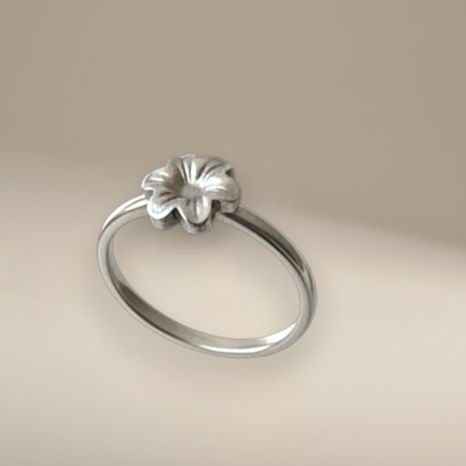 Bedrock Rose sterling silver ring featuring a dainty six-petal meadow flower design on a slim band, size 5.25.