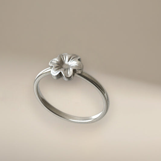 Bedrock Rose sterling silver ring featuring a dainty six-petal meadow flower design on a slim band, size 5.25.