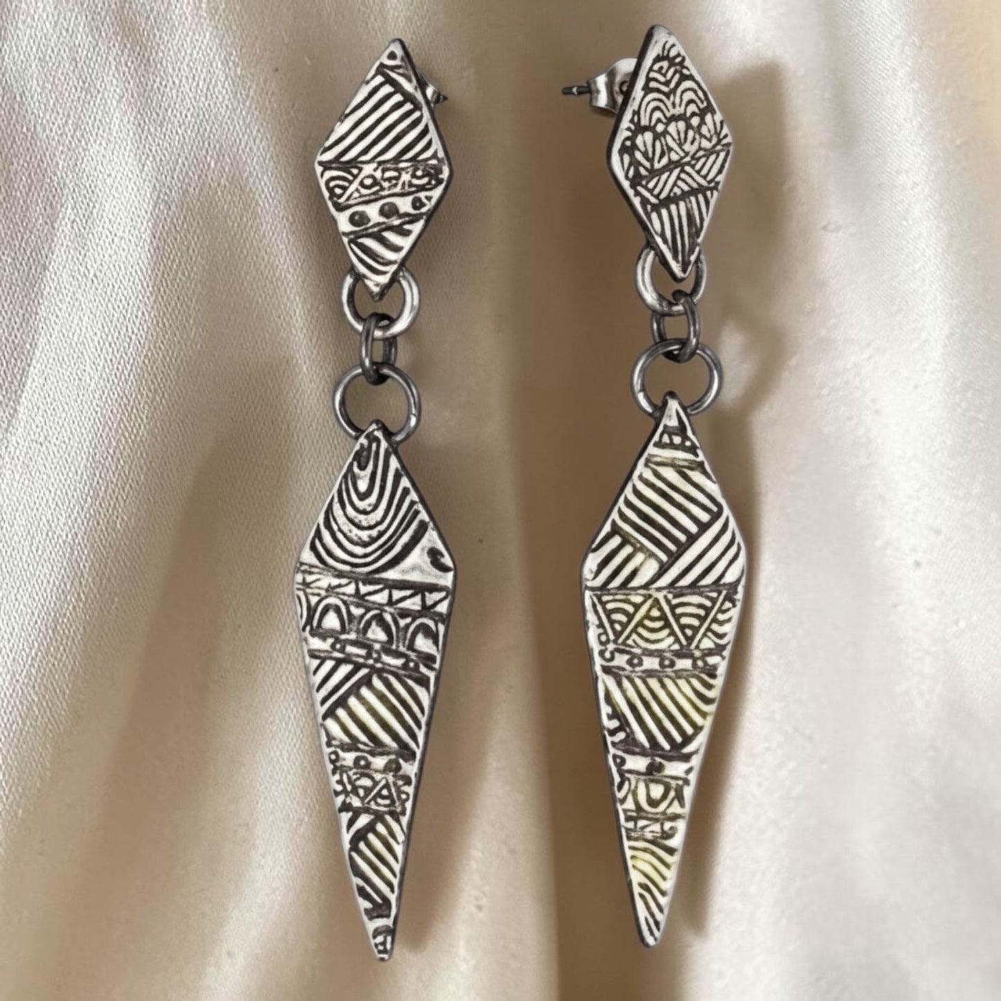 Bedrock Rose fine silver drop earrings featuring hand-stamped geometric quilt patterns in an elongated diamond shape.