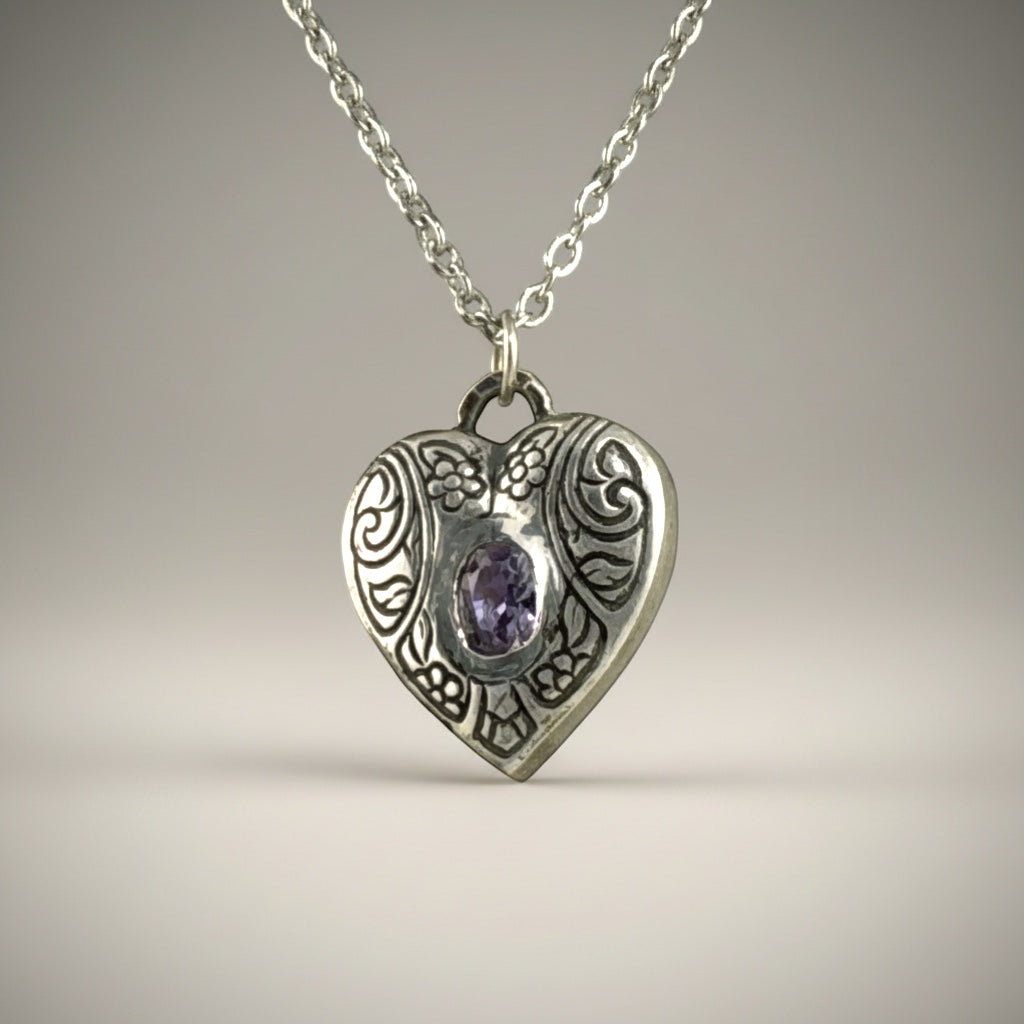 Bedrock Rose silver heart pendant with engraved floral details and a purple amethyst CZ stone.