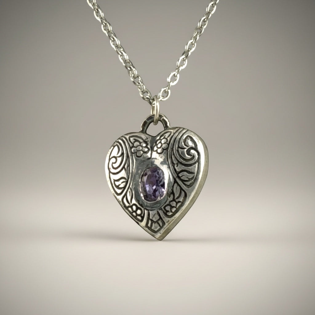Bedrock Rose silver heart pendant with engraved floral details and a purple amethyst CZ stone.