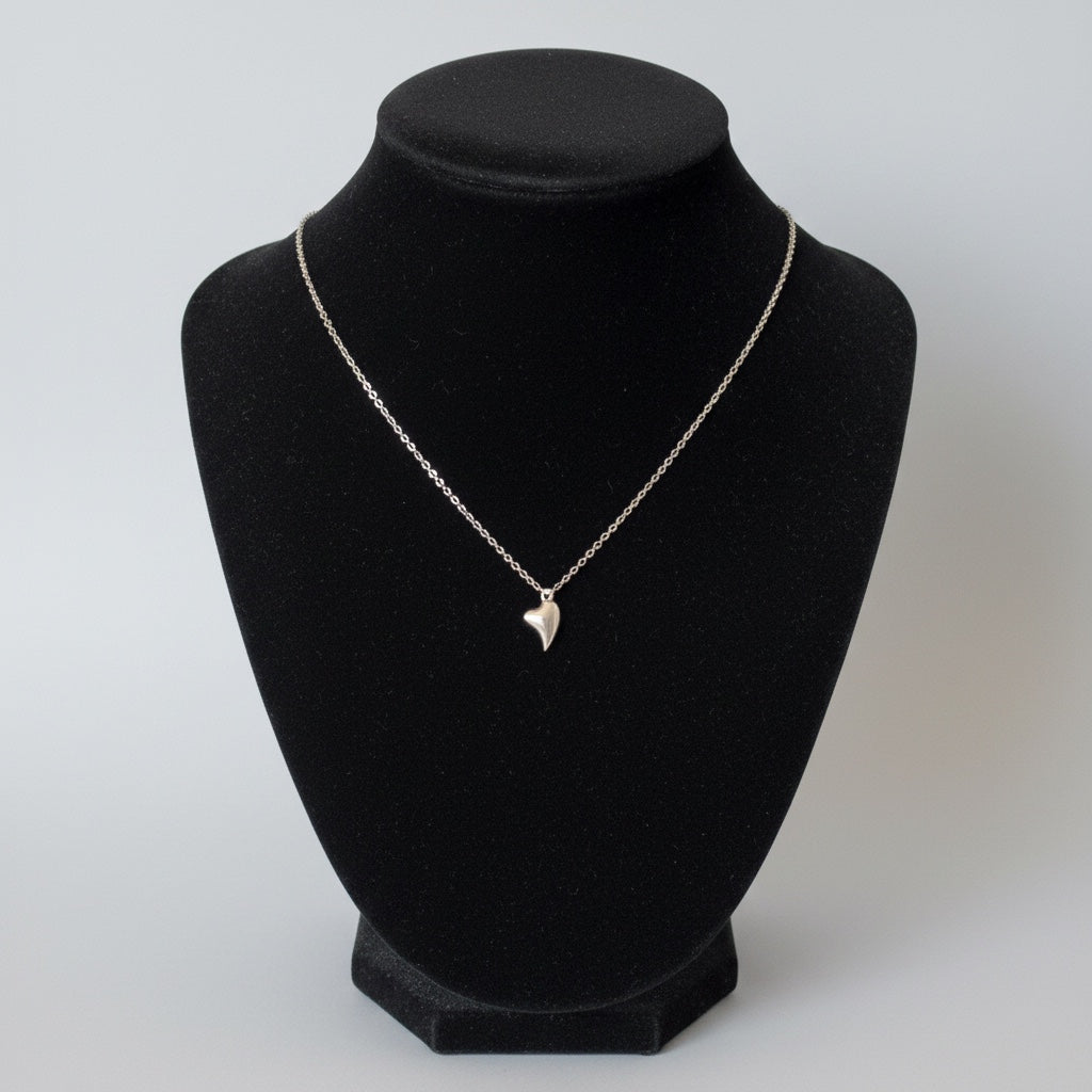 Bedrock Rose fine silver puffed heart pendant on a 16-inch faceted hypoallergenic stainless steel chain