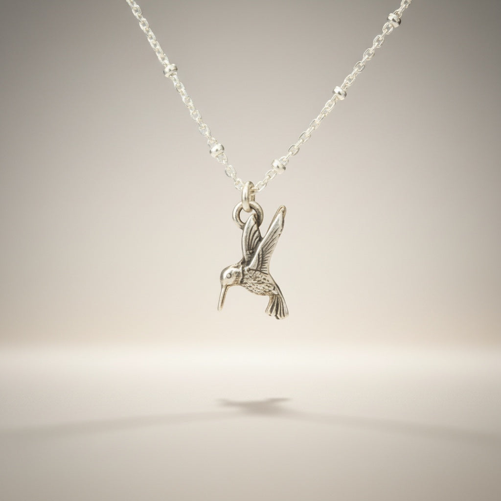 Bedrock Rose sterling silver hummingbird necklace with a delicate satellite chain. Perfect for nature lovers.