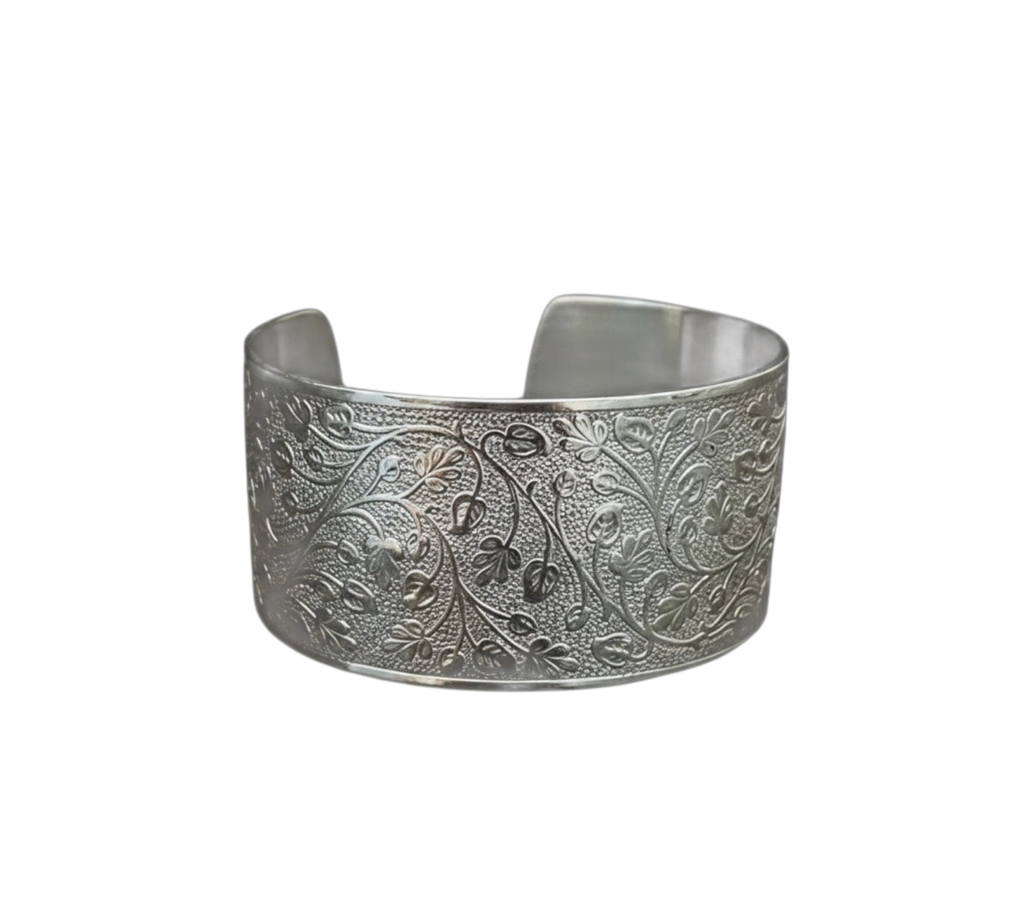Bedrock Rose silver wide cuff bracelet featuring an intricate embossed leafy vine pattern on a polished metal surface.