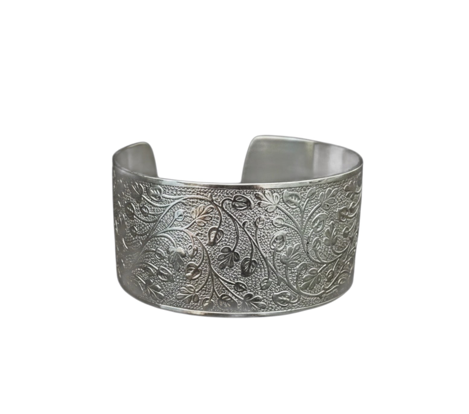 Bedrock Rose silver wide cuff bracelet featuring an intricate embossed leafy vine pattern on a polished metal surface.