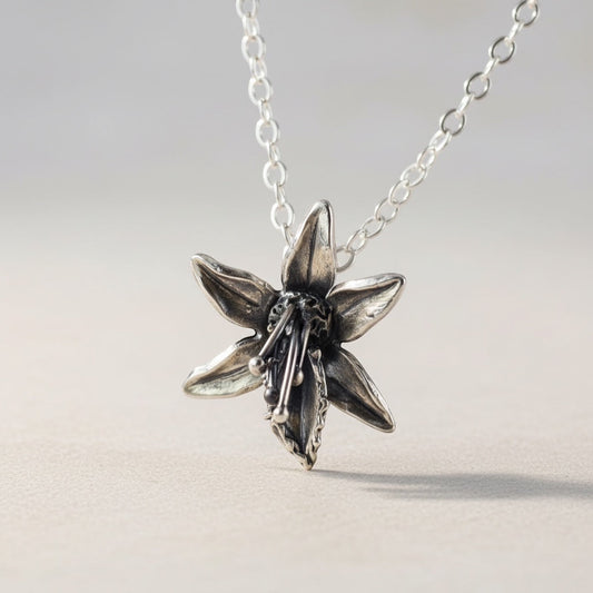 Bedrock Rose fine silver orchid pendant with sterling silver chain. Handcrafted floral statement necklace.